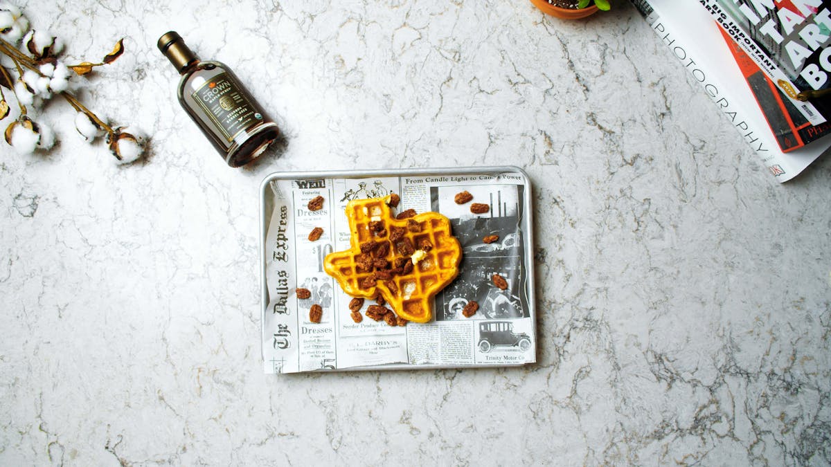a waffle shaped like Texas on a tray